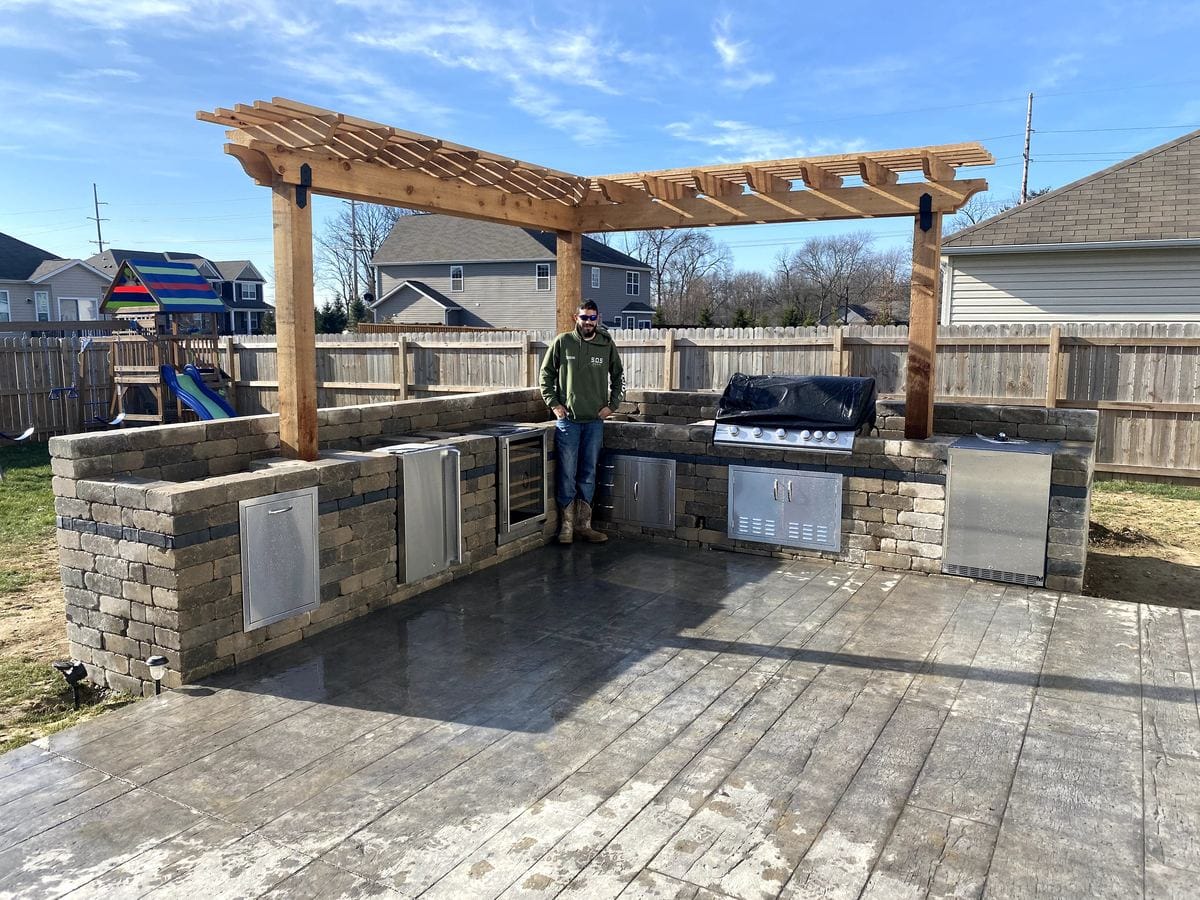 Outdoor kitchen and pergola on a finished patio