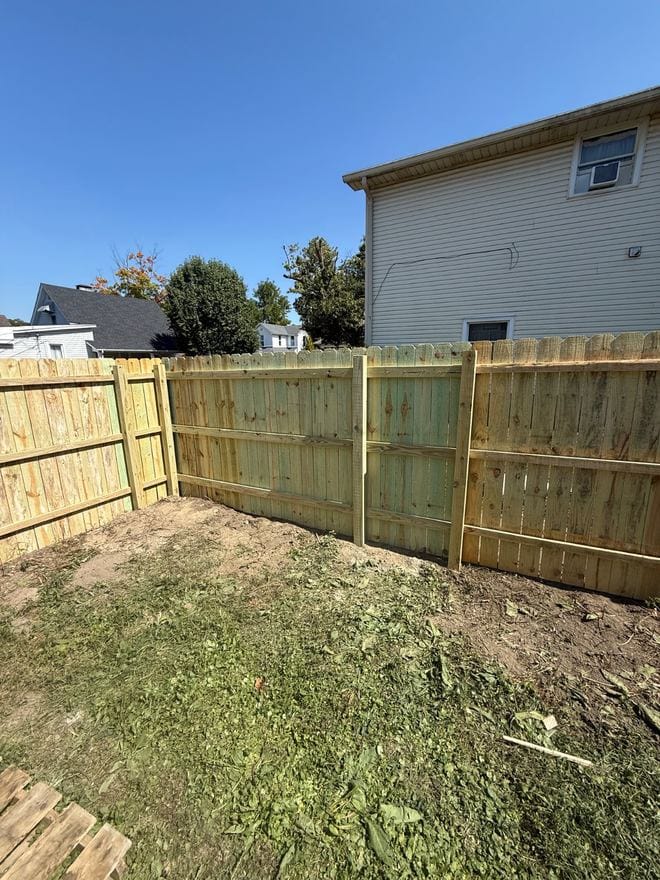 Treated wood privacy fence