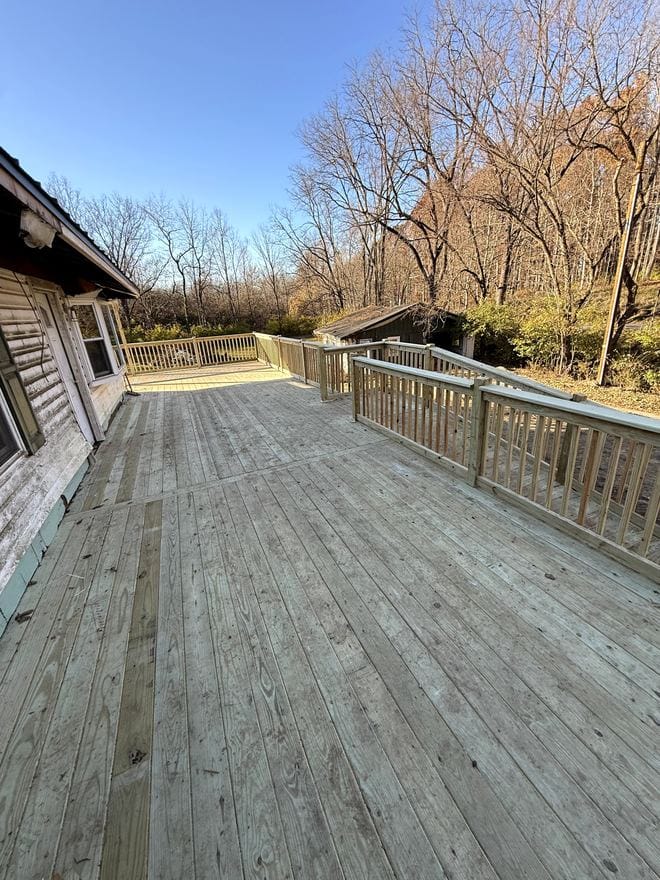 Large wood deck running along the back of a house