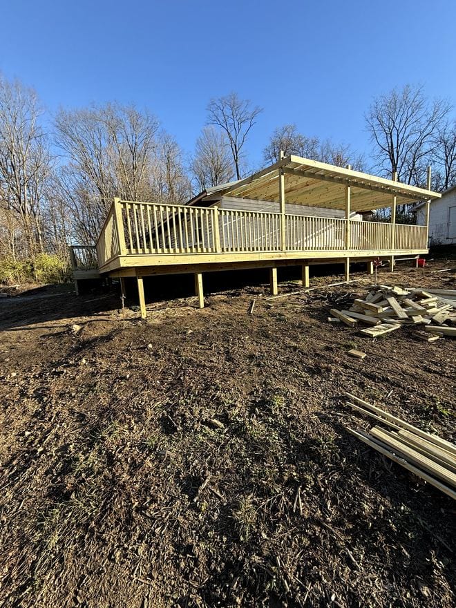 Deck framing on posts behind a house