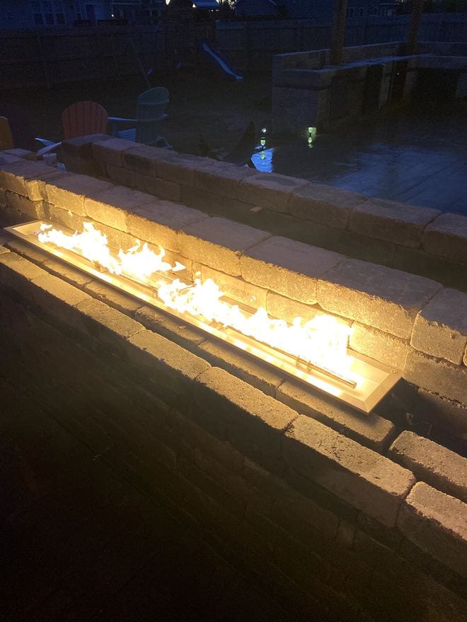 Paver patio with a stone fire pit